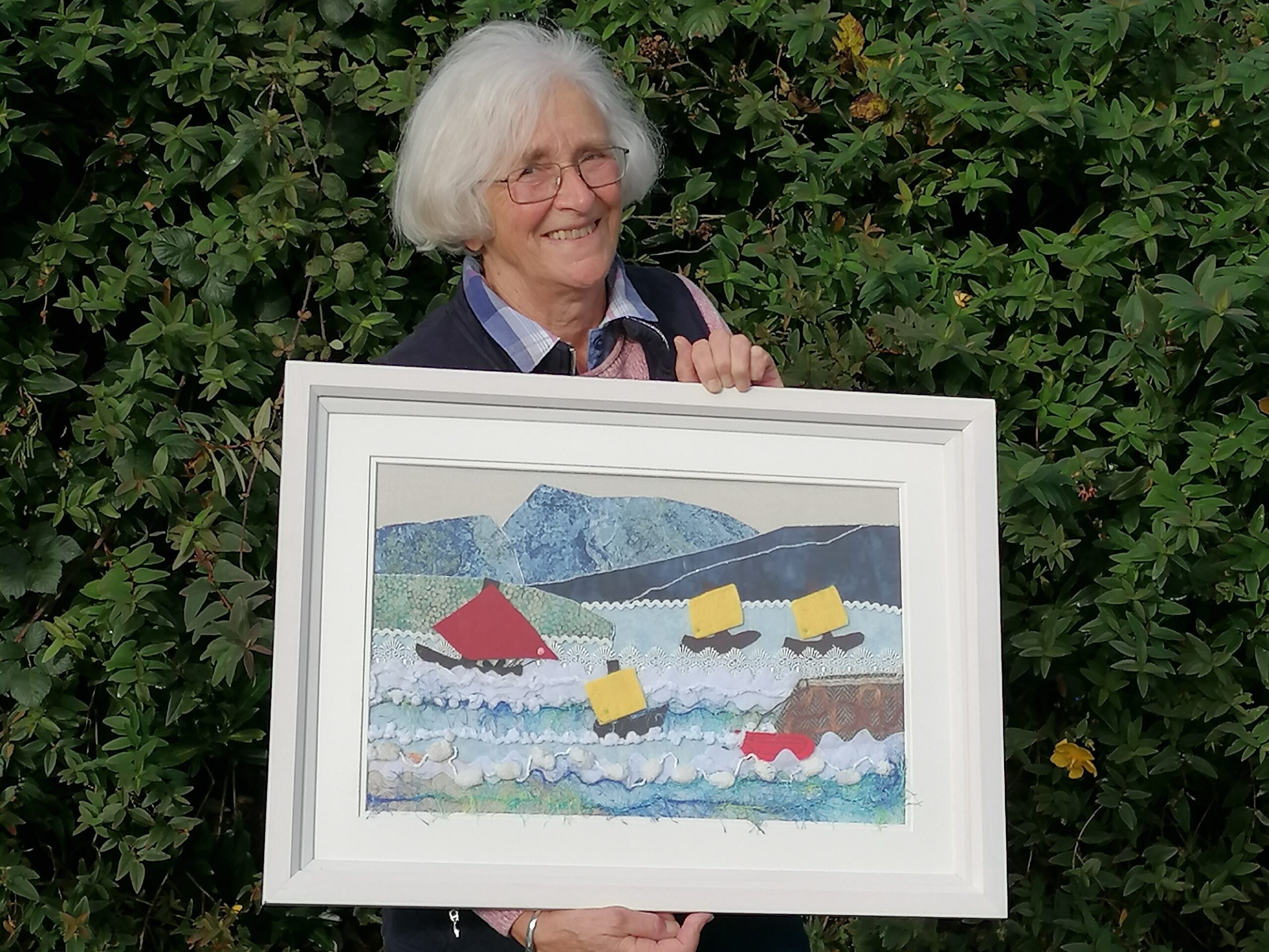Lady holding a picture of boats